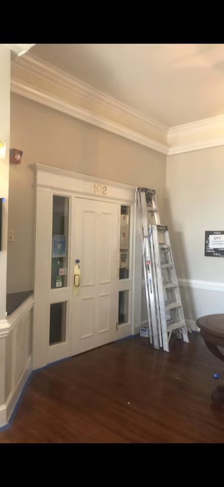 Interior renovation in progress with crown molding and paneling