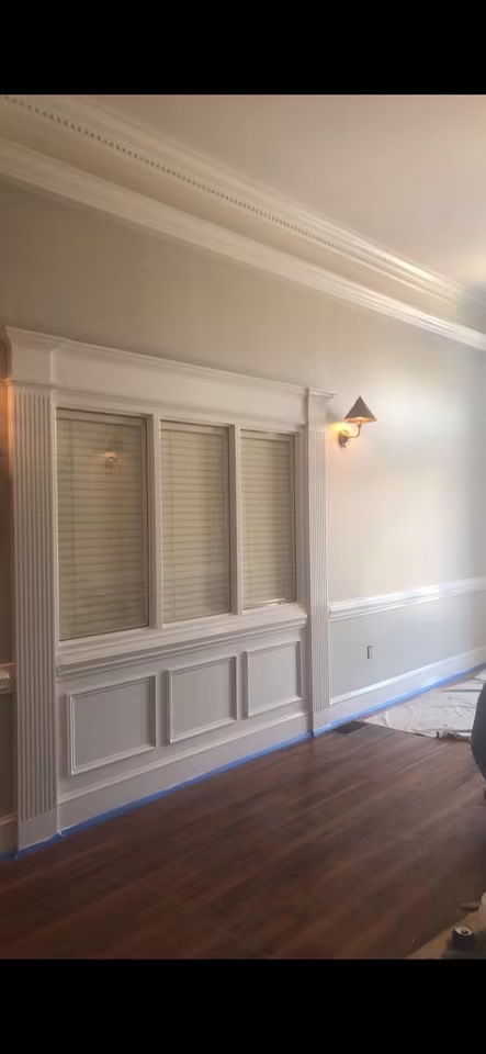 Interior millwork with paneled wainscoting and window casing