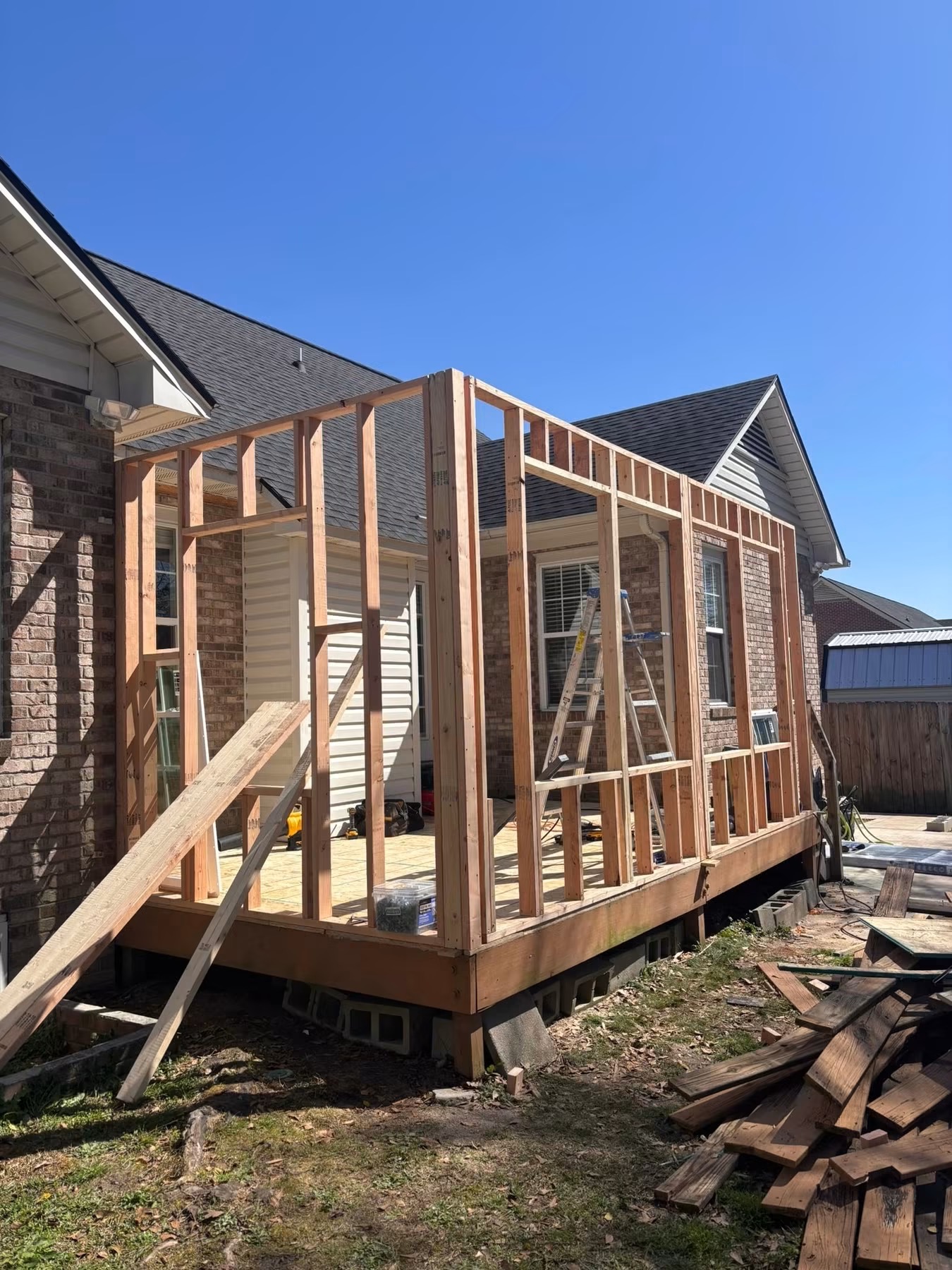 Room addition framed out over a new deck foundation