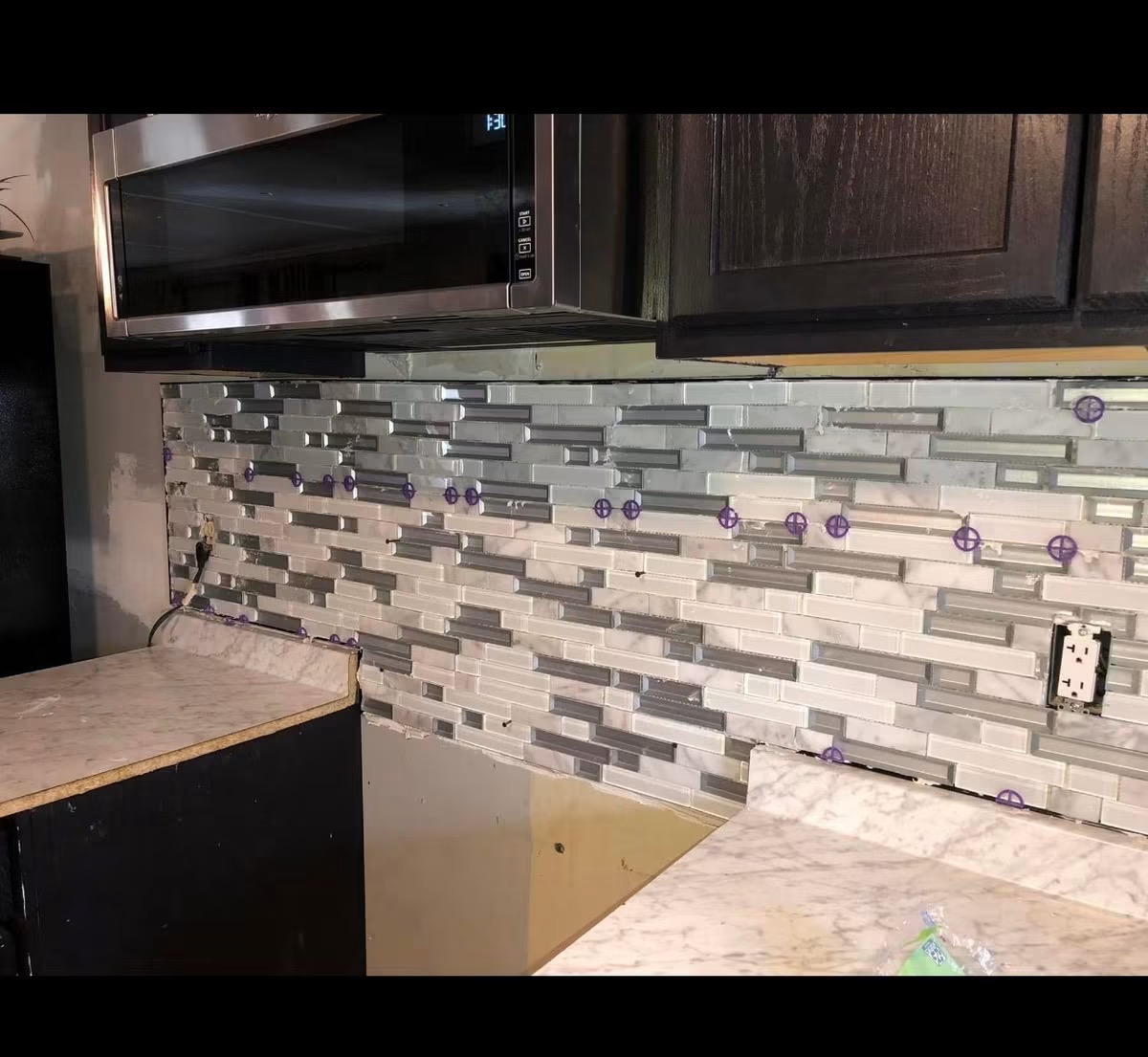 Kitchen backsplash tile set around outlets and countertops