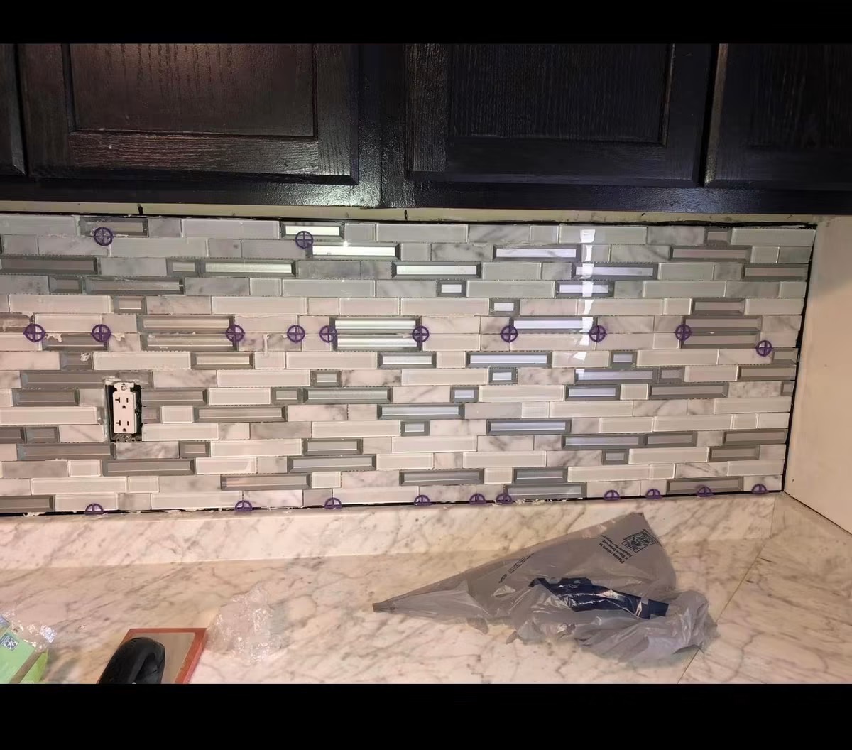 Glass and marble mosaic kitchen backsplash tile installation
