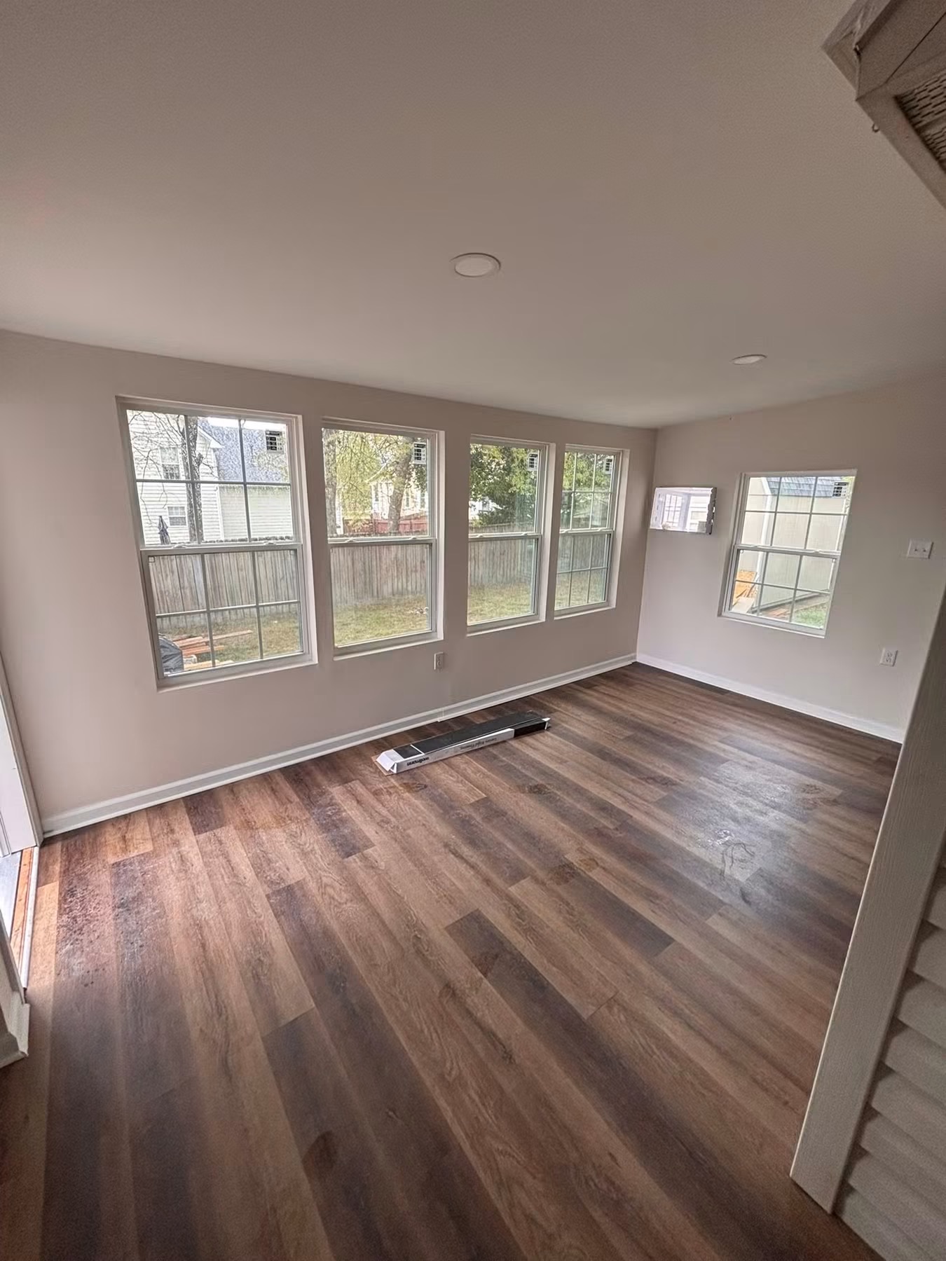 Completed room with new luxury vinyl plank flooring and fresh paint