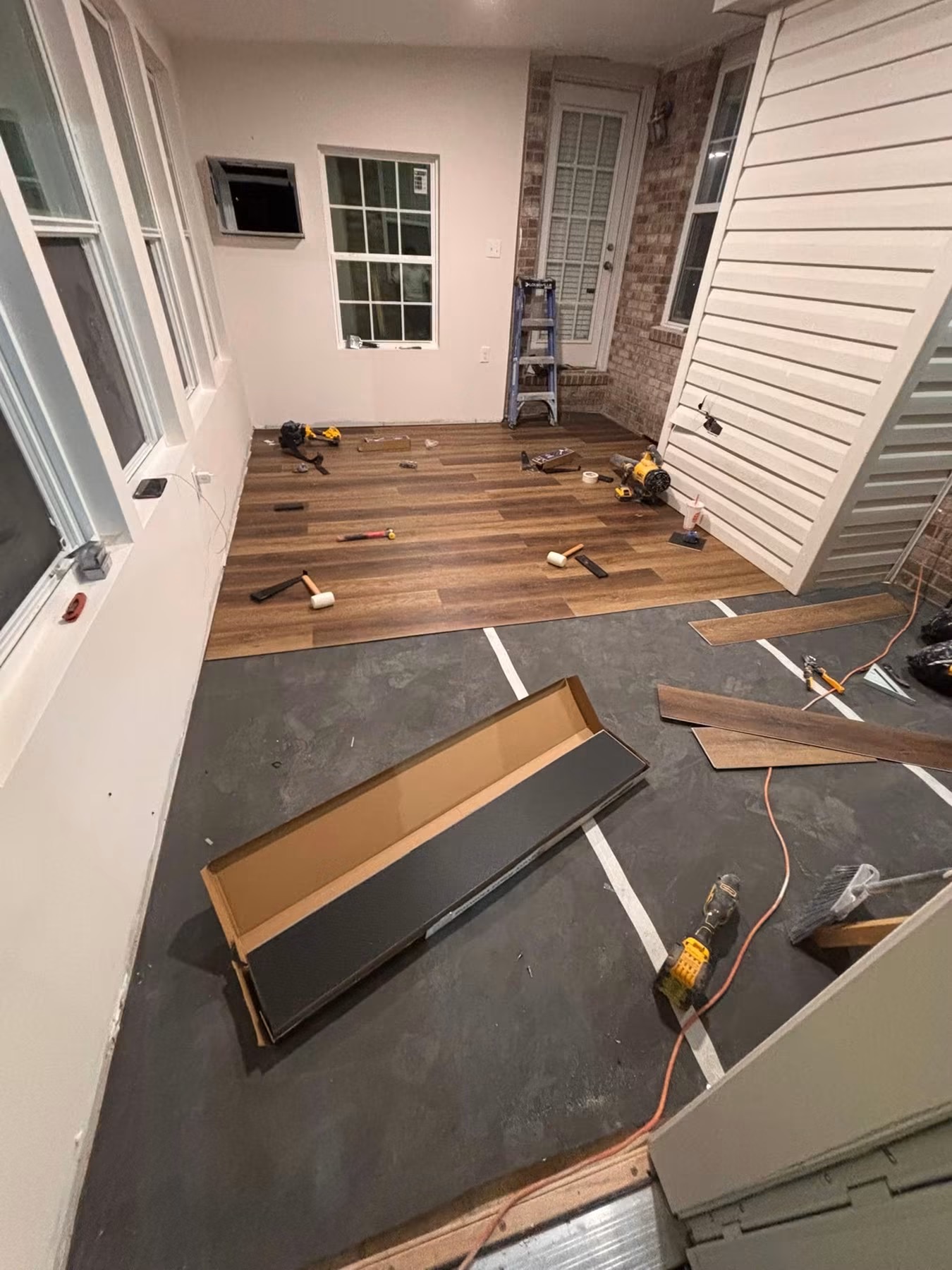 Vinyl plank flooring installation on an enclosed porch