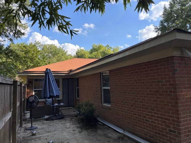 Exterior view of completed roofing and gutter work